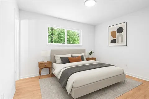 a bedroom with a bed and a painting on the wall