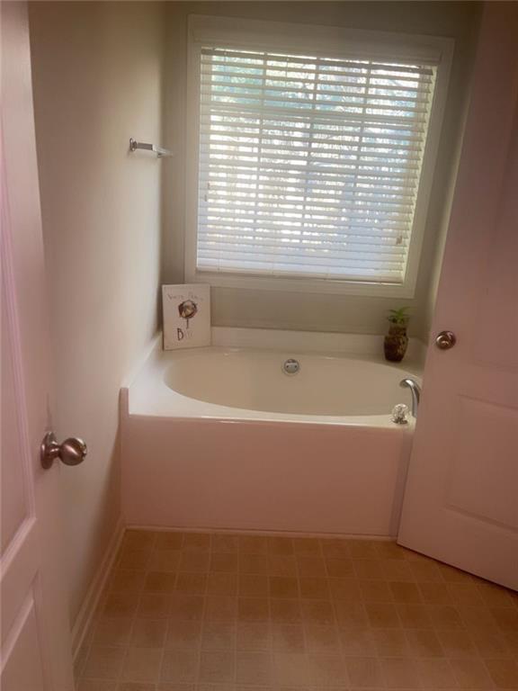 114 Crescent Woode Way Dallas, GA 30157 - Photo 22 of 25 a bathroom with a bathtub and a window