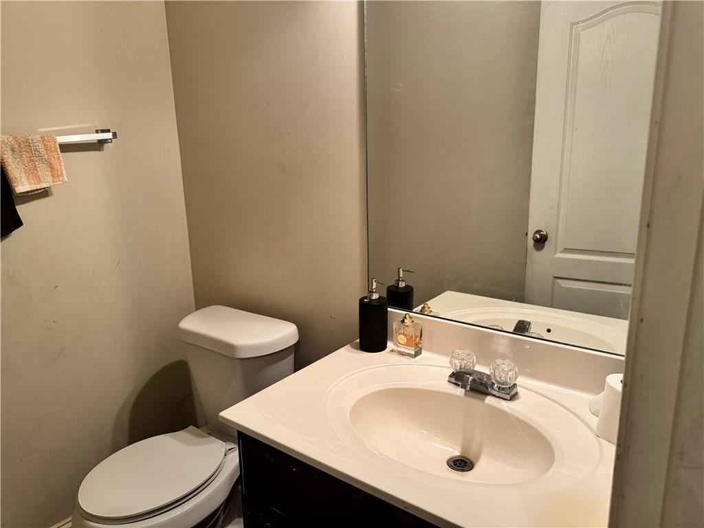 114 Crescent Woode Way Dallas, GA 30157 - Photo 8 of 25 a bathroom with a sink a toilet and a mirror
