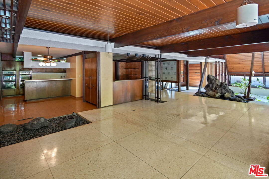 1335 Shadybrook Drive Beverly Hills, CA 90210 - Photo 11 of 39 a view of a garage with table and chairs