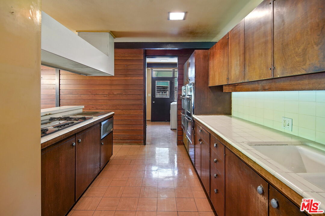 1335 Shadybrook Drive Beverly Hills, CA 90210 - Photo 13 of 39 a kitchen with stainless steel appliances granite countertop a sink and cabinets