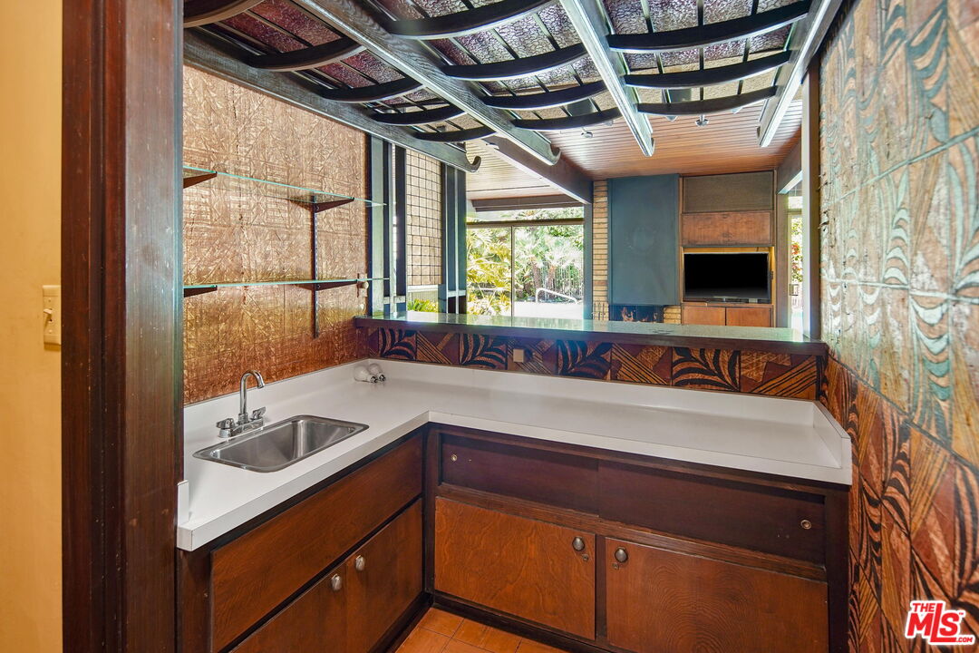 1335 Shadybrook Drive Beverly Hills, CA 90210 - Photo 16 of 39 a kitchen with a sink and a window