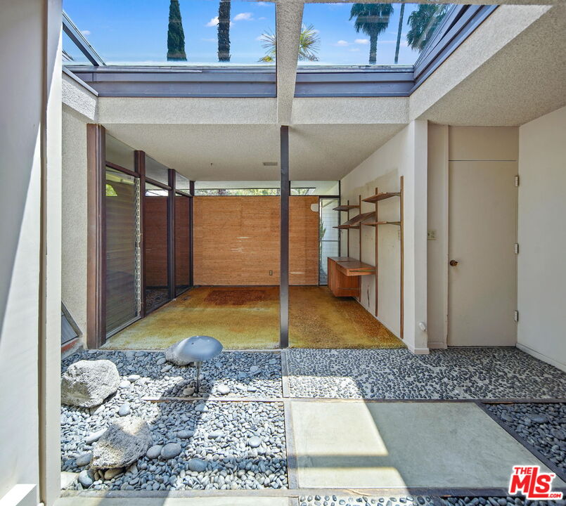 1335 Shadybrook Drive Beverly Hills, CA 90210 - Photo 21 of 39 a view of a hallway with a glass door