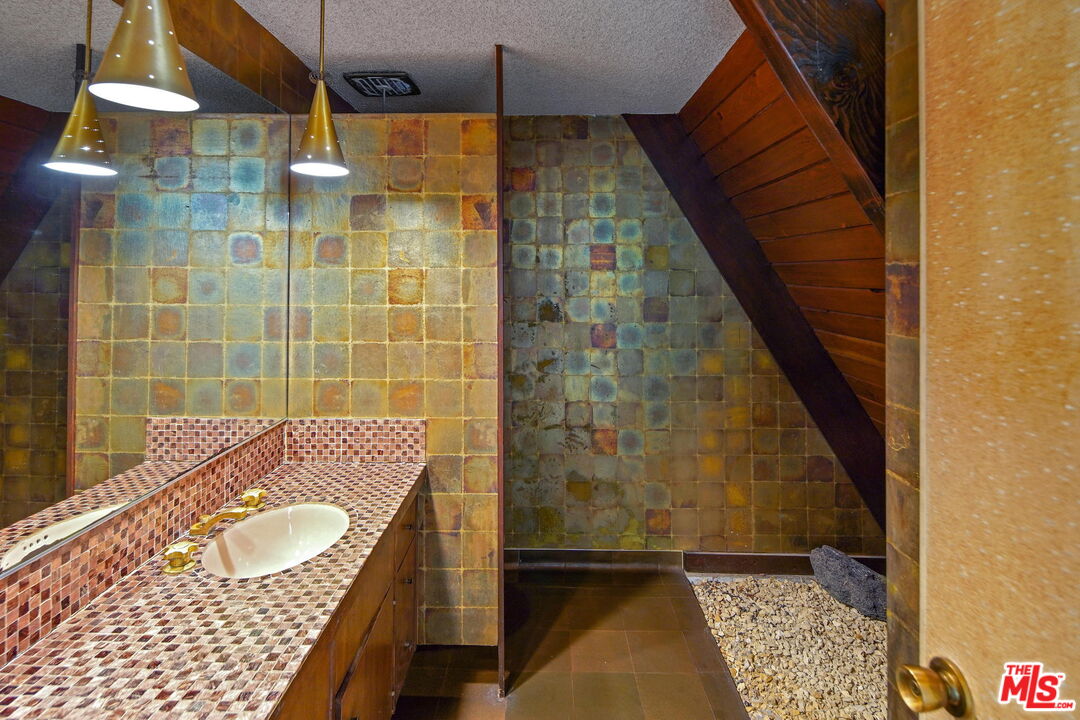 1335 Shadybrook Drive Beverly Hills, CA 90210 - Photo 22 of 39 a bathroom with a sink and shower