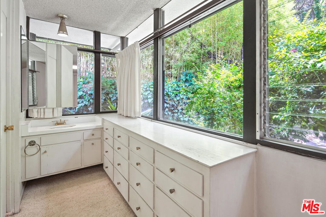 1335 Shadybrook Drive Beverly Hills, CA 90210 - Photo 33 of 39 a spacious bathroom with double vanity and a large window