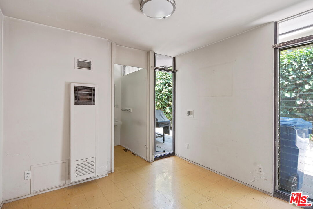 1335 Shadybrook Drive Beverly Hills, CA 90210 - Photo 34 of 39 an empty room with windows