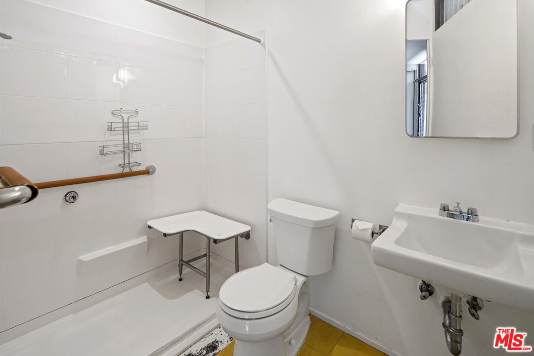 1335 Shadybrook Drive Beverly Hills, CA 90210 - Photo 35 of 39 a white toilet sitting next to a bathroom sink