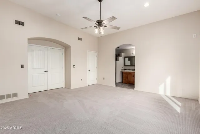 a view of a livingroom with a ceiling fan and window