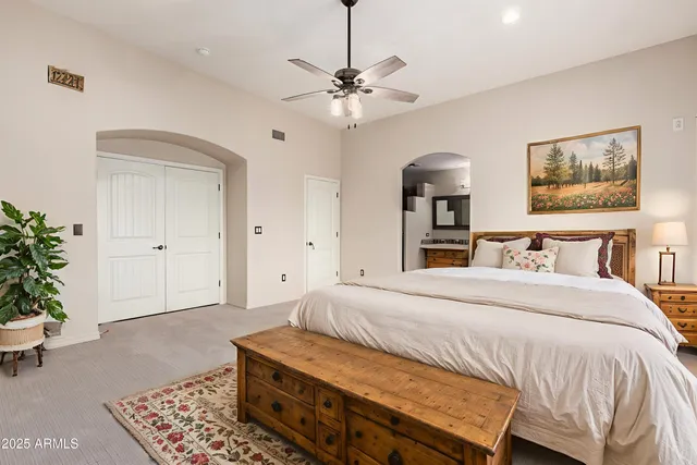 a bedroom with a bed and a chandelier