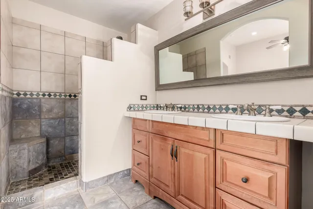 a bathroom with a sink a vanity and a mirror