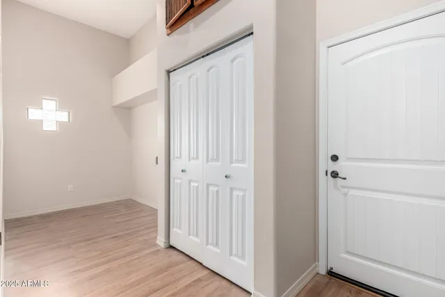 a view of a hallway with wooden floor