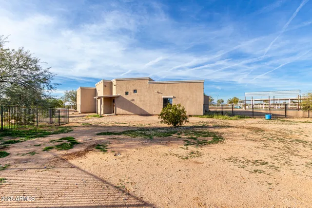 a view of a dirt road and a building