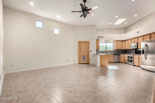a view of a kitchen with a sink and stainless steel appliances