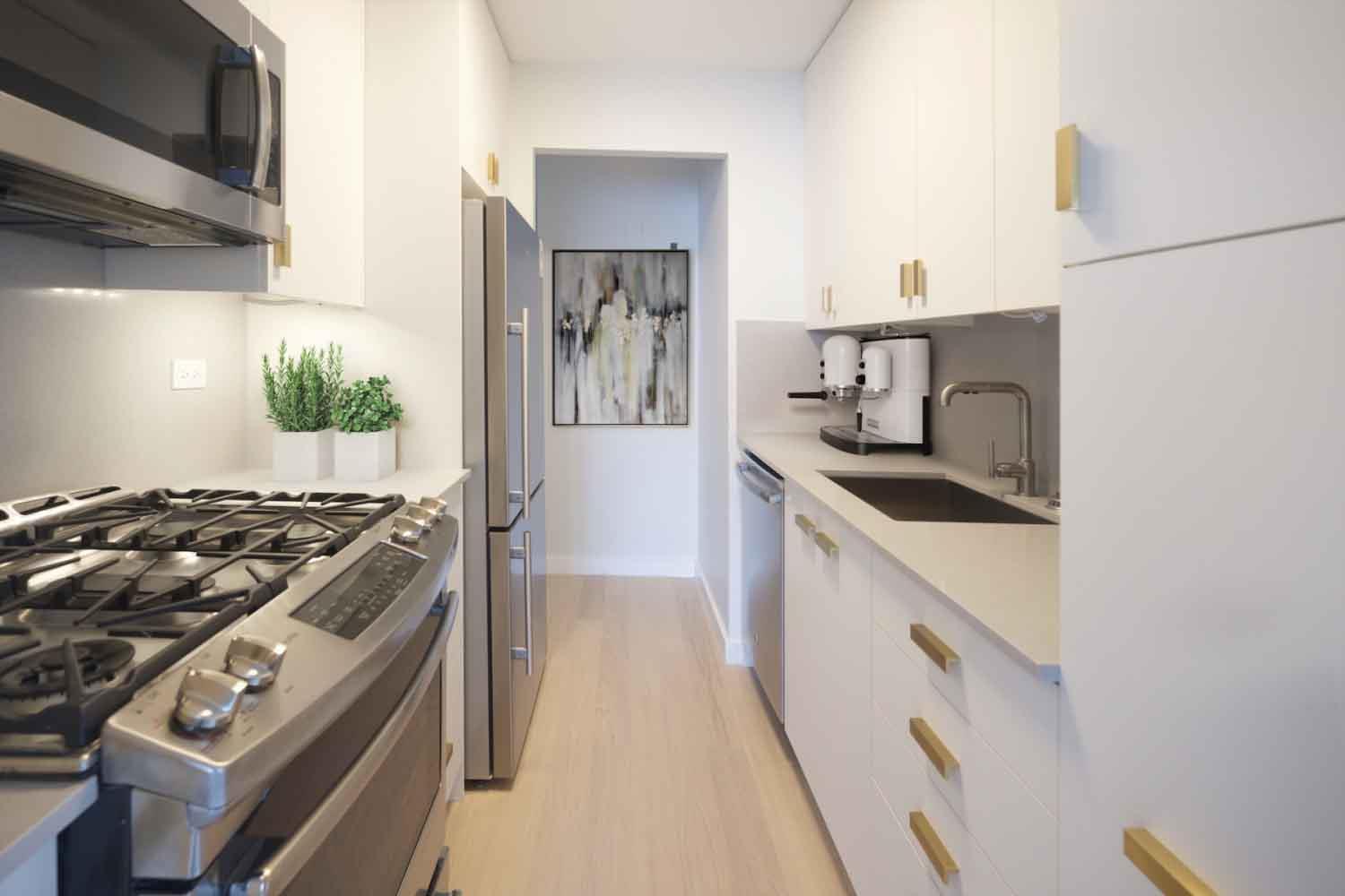 20 Waterside Plaza, Unit 25J Manhattan, NY 10010 - Photo 1 of 11 a kitchen with a stove and a sink