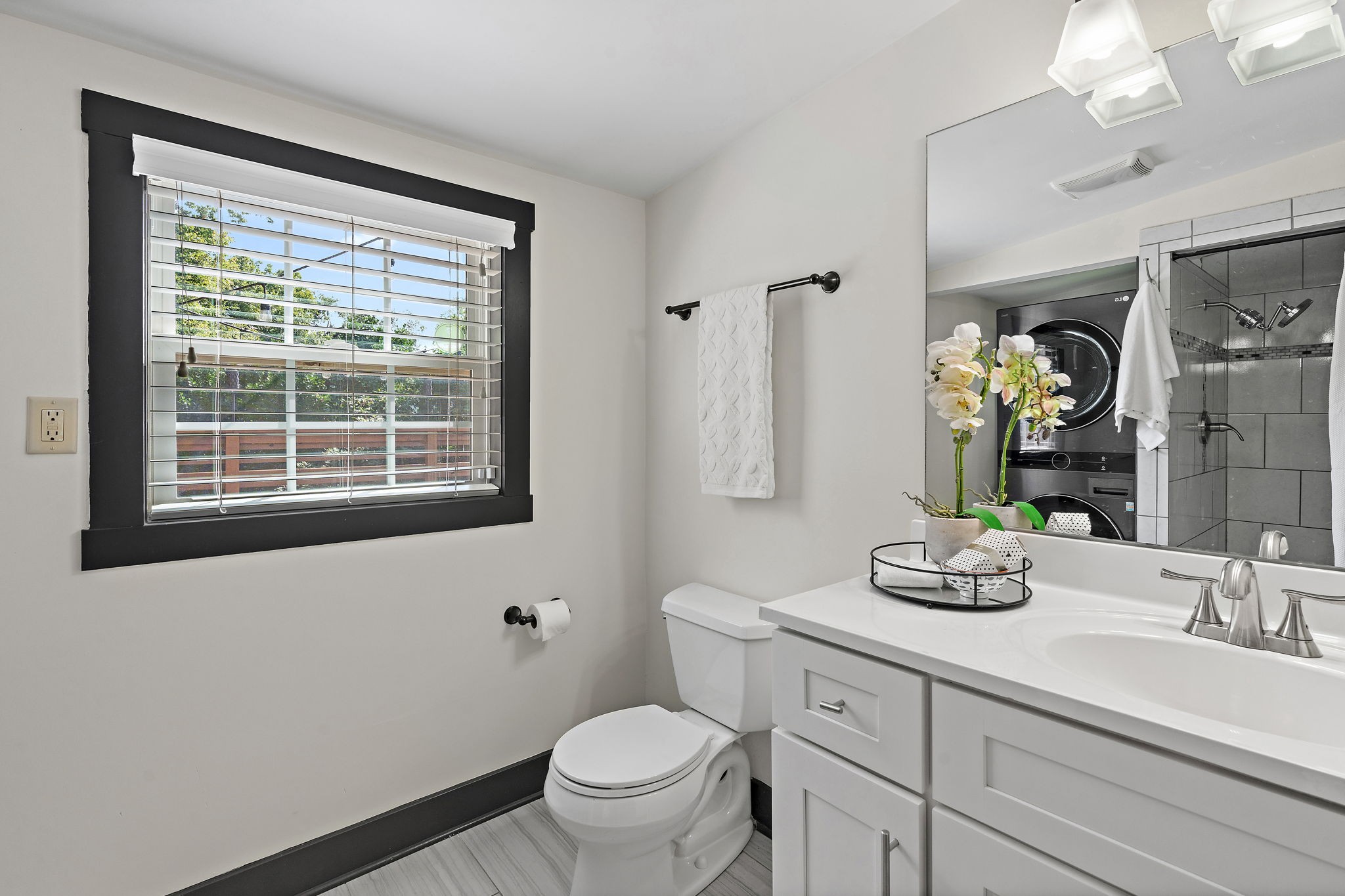 2614 Live Oak Road Nashville, TN 37210 - Photo 15 of 37 a bathroom with a toilet a sink and a large mirror