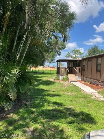 a view of a house with a yard balcony and sitting area