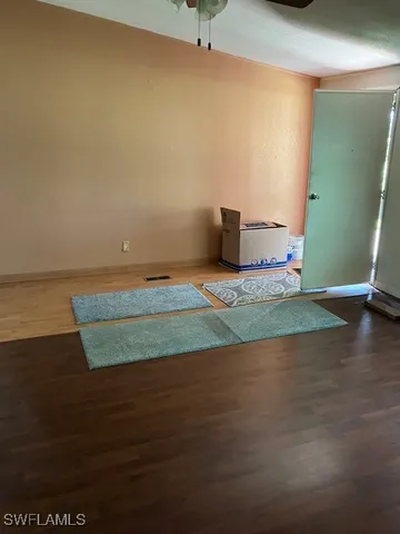 a view of a room with wooden floor