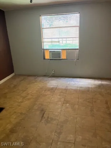 a view of an empty room and a window