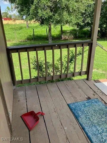 a view of porch with a floor to ceiling window next to a yard