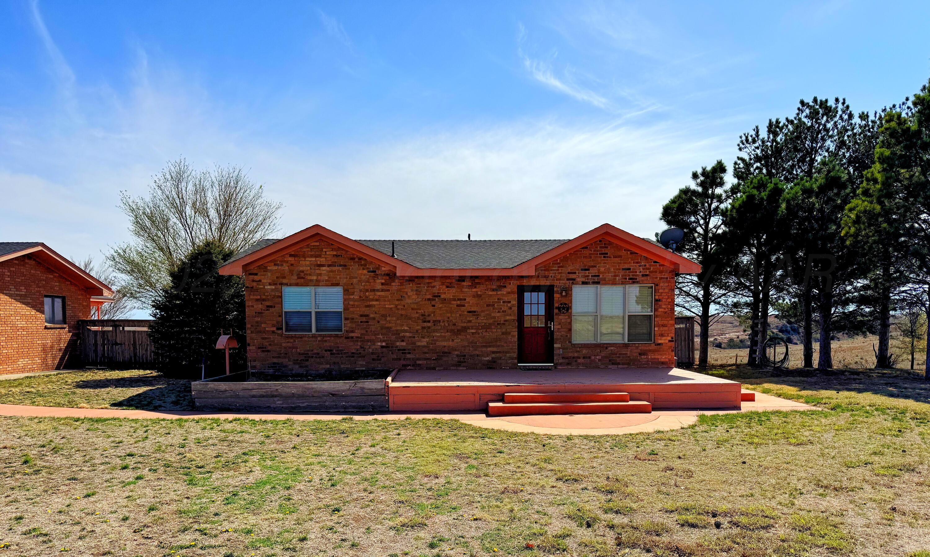 12885 Highway 83 Perryton, TX 79070 - Photo 26 of 40 a front view of a house with a yard