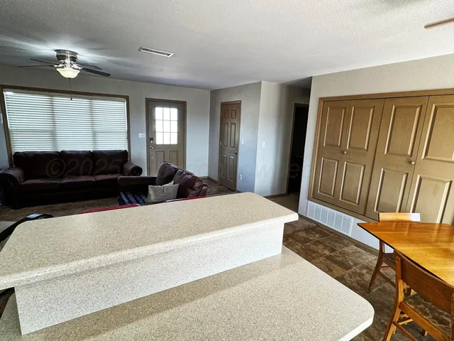 a living room with a bed furniture and a window