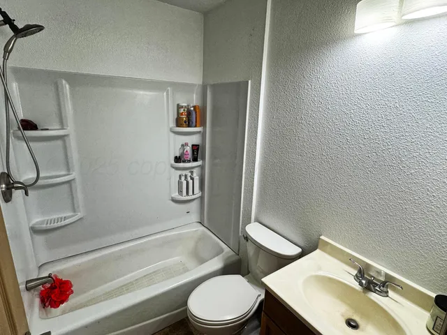 a bathroom with a toilet sink and shower