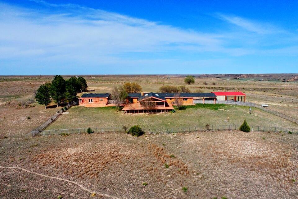 12885 Highway 83 Perryton, TX 79070 - Photo 40 of 40 an outdoor view of a house with a yard