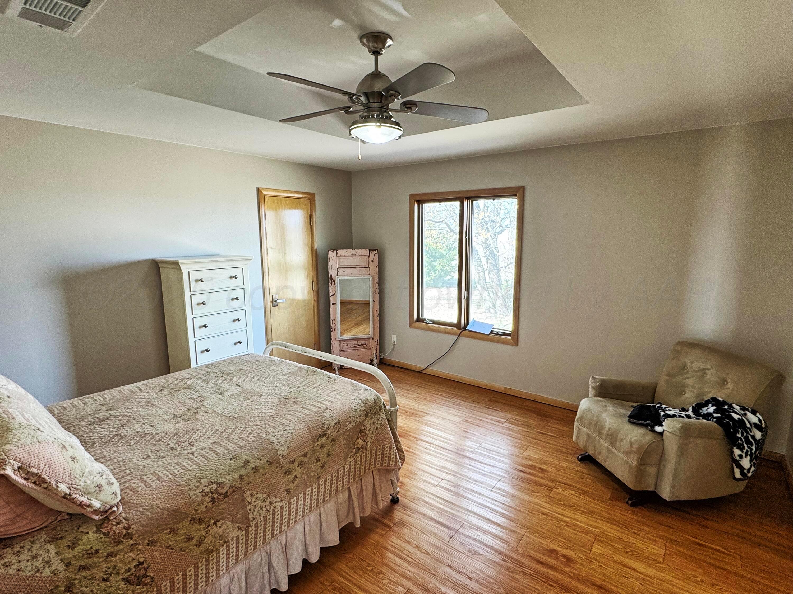 12885 Highway 83 Perryton, TX 79070 - Photo 10 of 40 a spacious bedroom with a bed and window