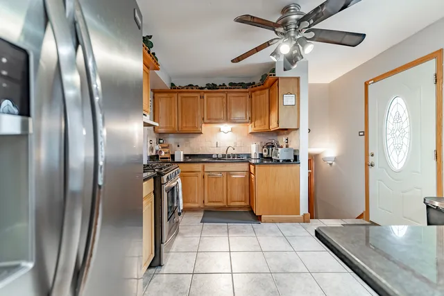 a kitchen with stainless steel appliances granite countertop a sink stove and cabinets