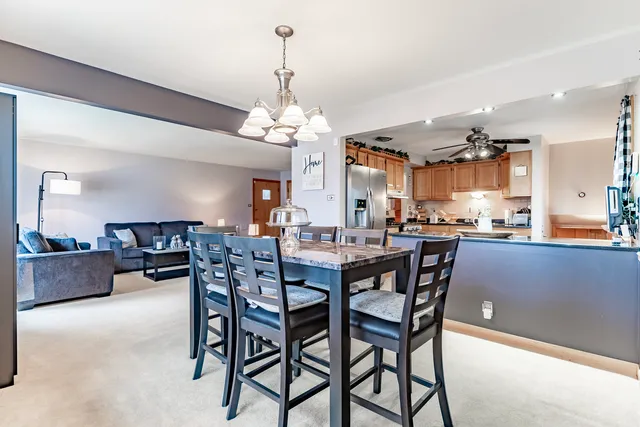 a view of a dining room with furniture and chandelier