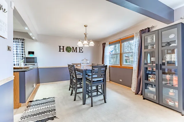 a dining room with furniture and window