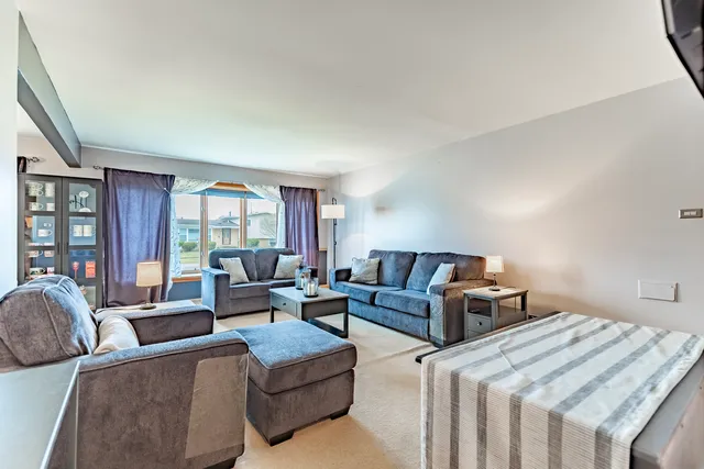 a bedroom with furniture and a large window