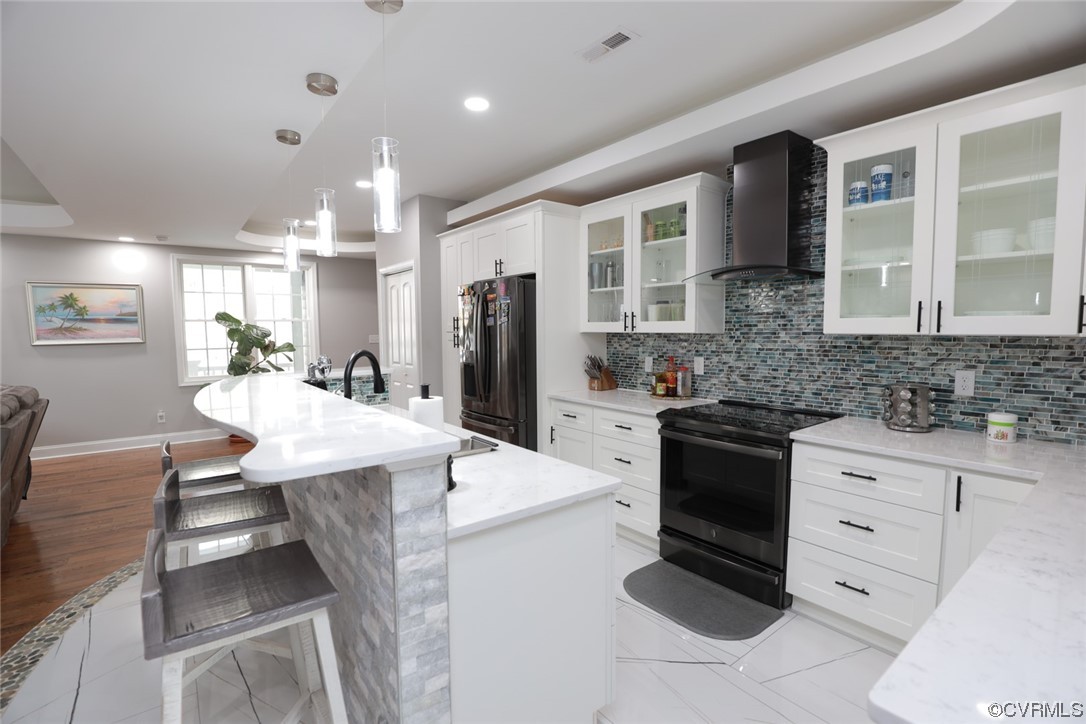 2420 Aberdeen Road Richmond, VA 23237 - Photo 20 of 50 a kitchen with stainless steel appliances kitchen island granite countertop a refrigerator a stove and a sink with cabinets