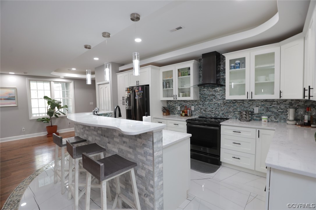 2420 Aberdeen Road Richmond, VA 23237 - Photo 24 of 50 a kitchen with stainless steel appliances kitchen island granite countertop a stove a sink a refrigerator and white cabinets with wooden floor