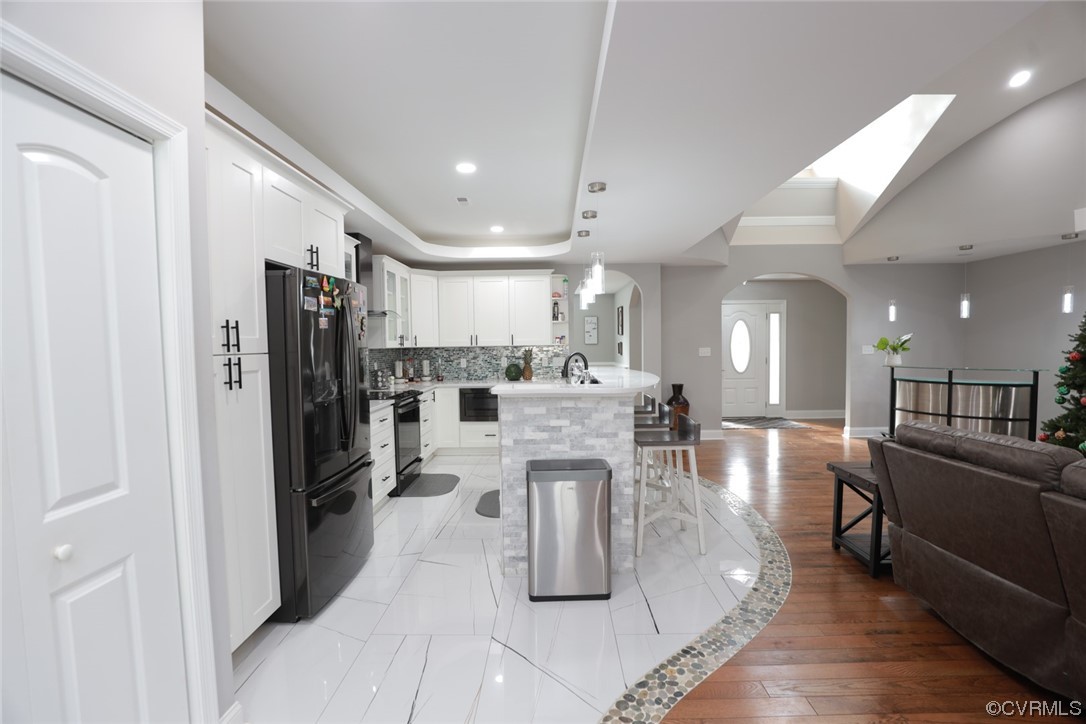 2420 Aberdeen Road Richmond, VA 23237 - Photo 29 of 50 a kitchen with stainless steel appliances kitchen island granite countertop a refrigerator and a stove top oven