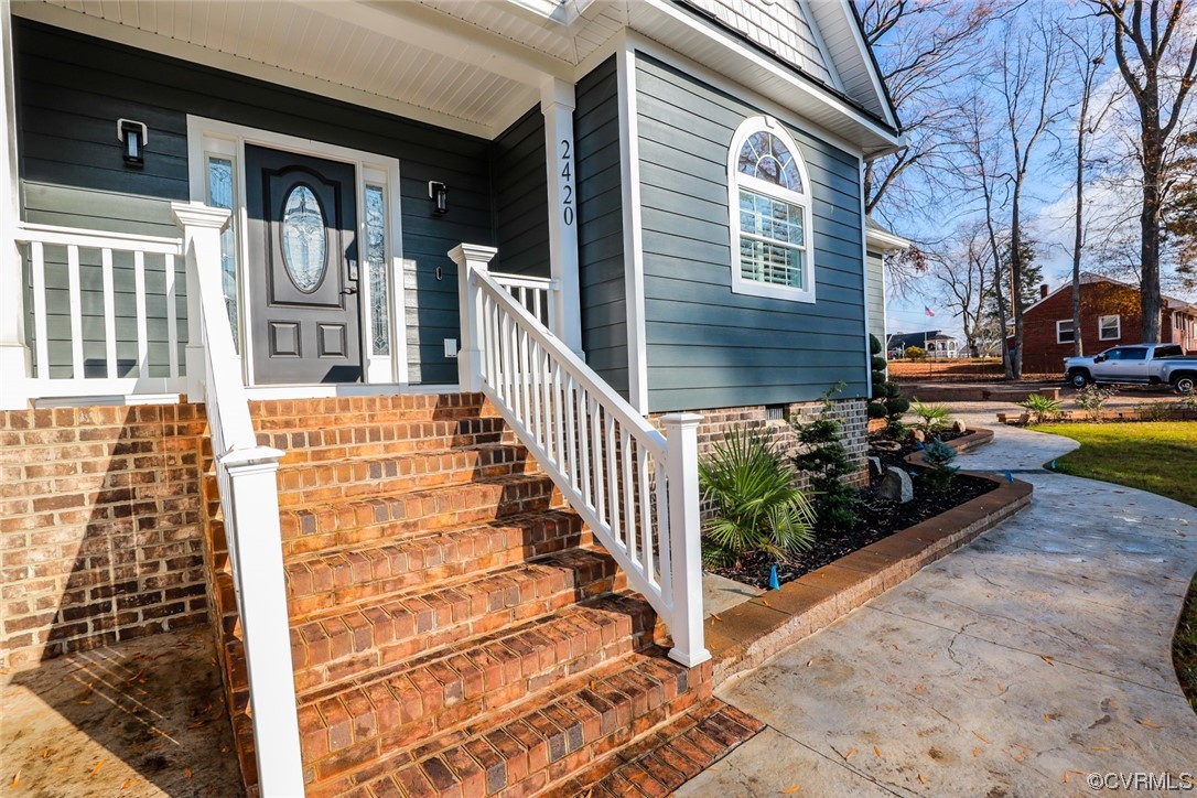 2420 Aberdeen Road Richmond, VA 23237 - Photo 4 of 50 a view of a brick house with large windows and a table
