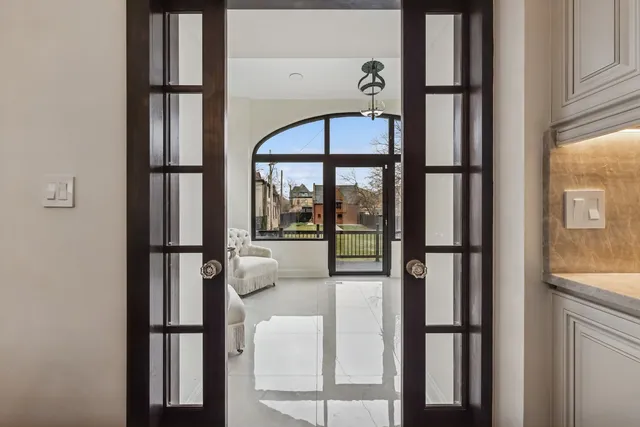 a bedroom with a bed and a large window