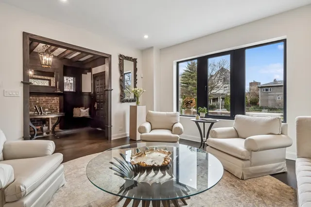a view of a roof deck with couches under an umbrella