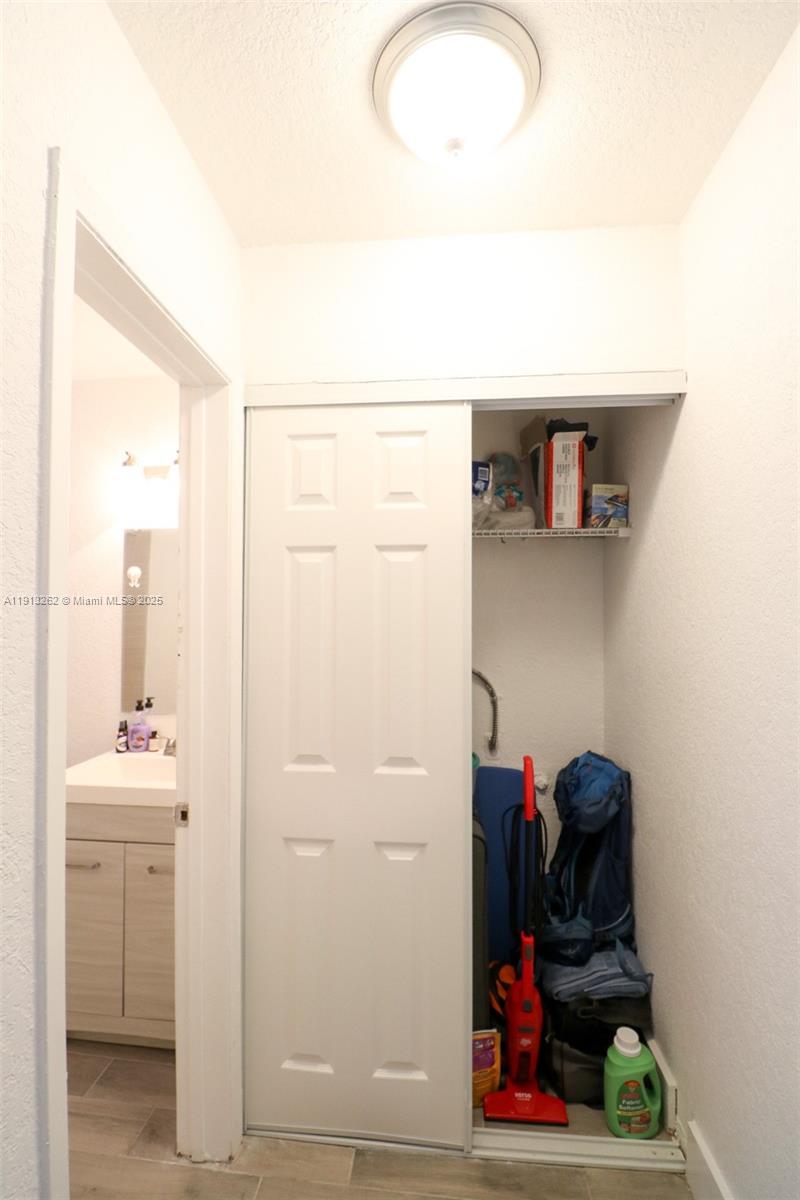 3071 Southwest 27th Avenue, Unit 5 Miami, FL 33133 - Photo 13 of 17 a view of hallway with washer and dryer