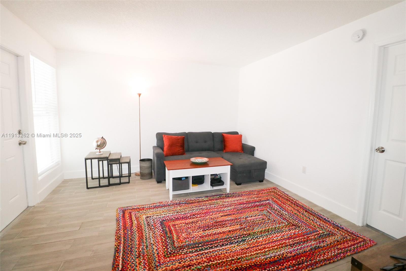 3071 Southwest 27th Avenue, Unit 5 Miami, FL 33133 - Photo 3 of 17 a living room with a bed and a couch