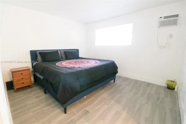 a bedroom with a bed and a couch