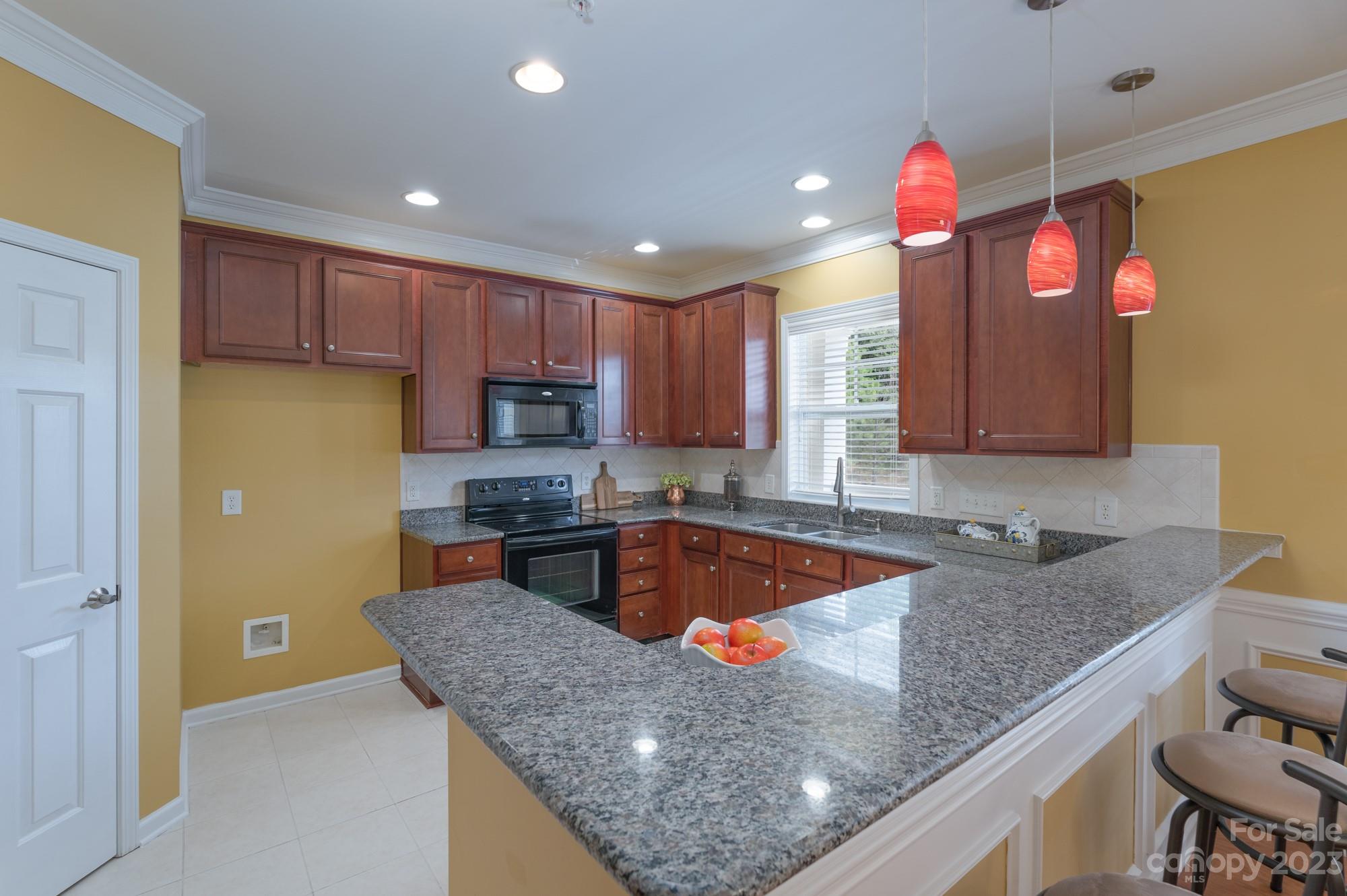 627 Sunfish Lane Tega Cay, SC 29708 - Photo 12 of 46 a kitchen with stainless steel appliances granite countertop a sink a stove and a refrigerator