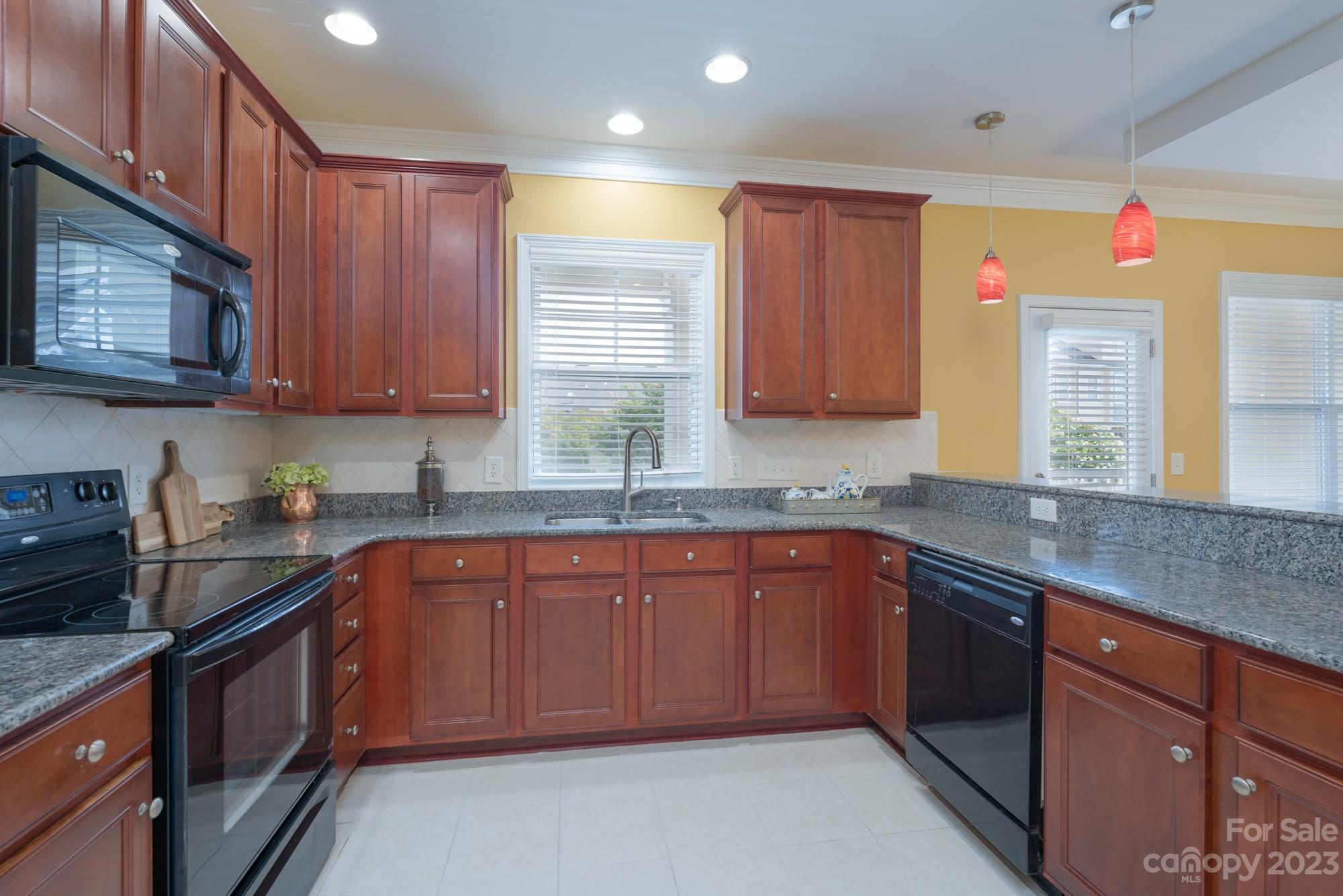 627 Sunfish Lane Tega Cay, SC 29708 - Photo 13 of 46 a kitchen with stainless steel appliances granite countertop wooden cabinets a sink and dishwasher