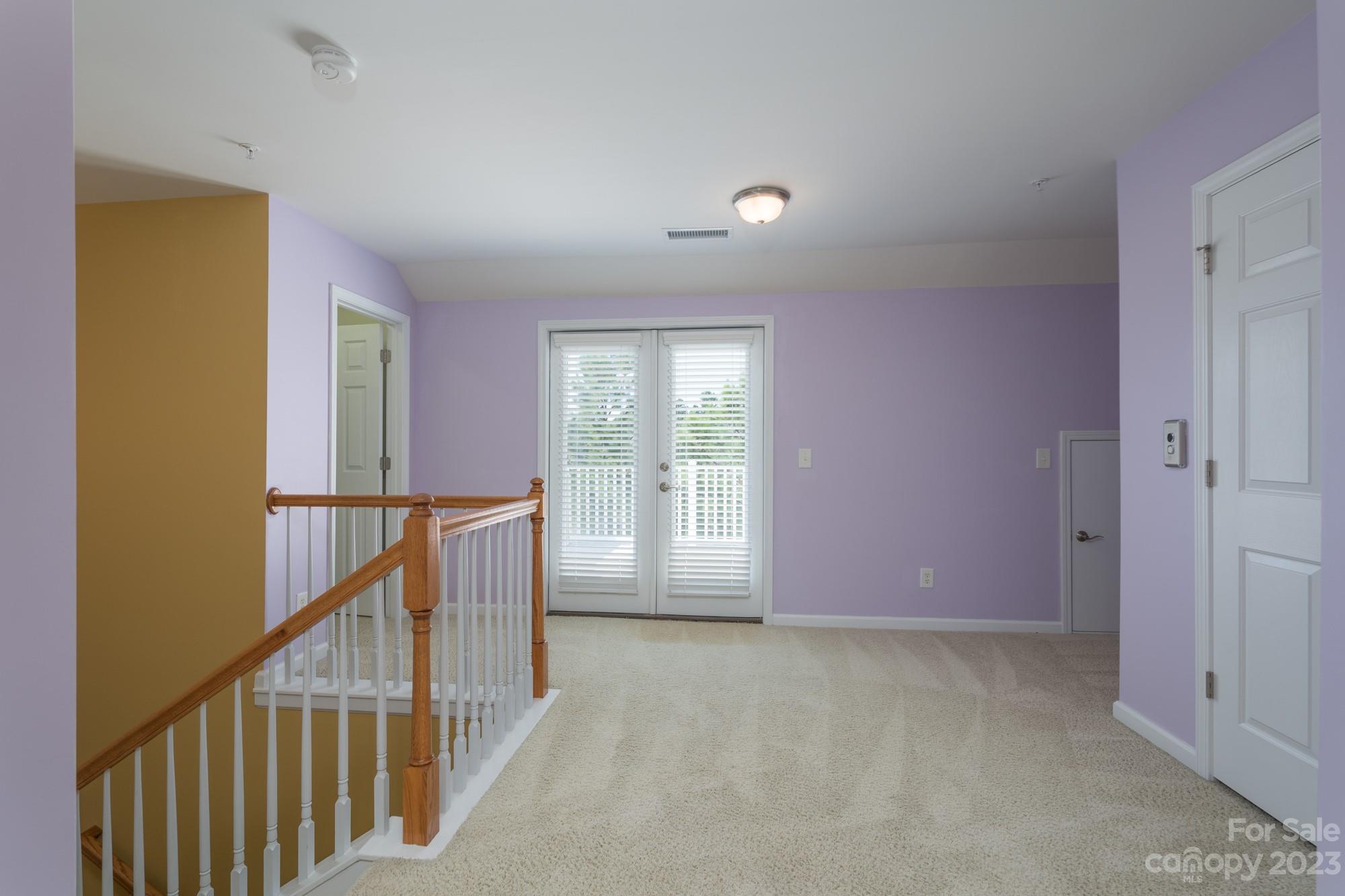 627 Sunfish Lane Tega Cay, SC 29708 - Photo 33 of 46 a view of an empty room with wooden floor and stairs