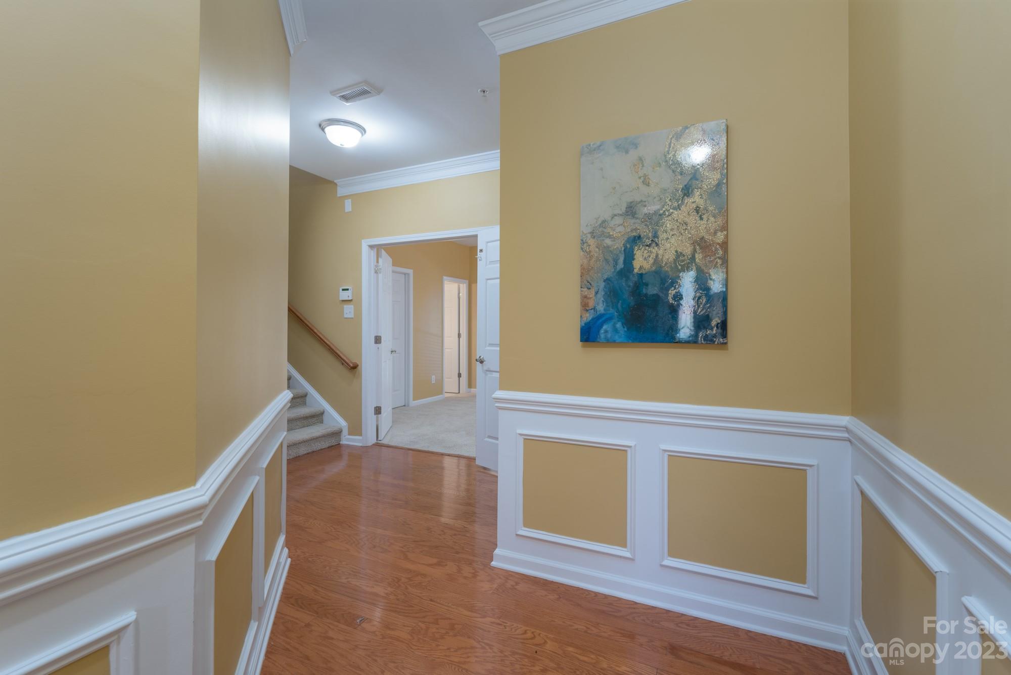 627 Sunfish Lane Tega Cay, SC 29708 - Photo 4 of 46 a view of a hallway with wooden floor and entryway