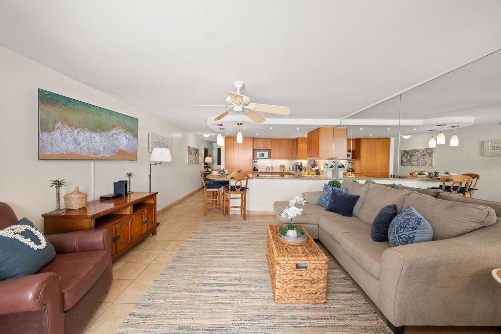 3785 Lower Honoapiilani Road, Unit 208 Lahaina, HI 96761 - Photo 21 of 50 a living room with furniture kitchen view and a chandelier