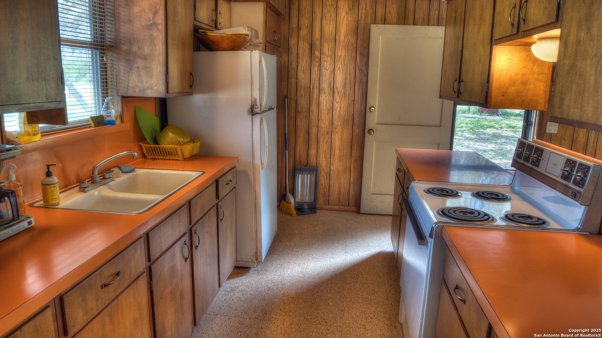 154 Weston Road Leakey, TX 78873 - Photo 33 of 39 a kitchen with a sink stove and a refrigerator