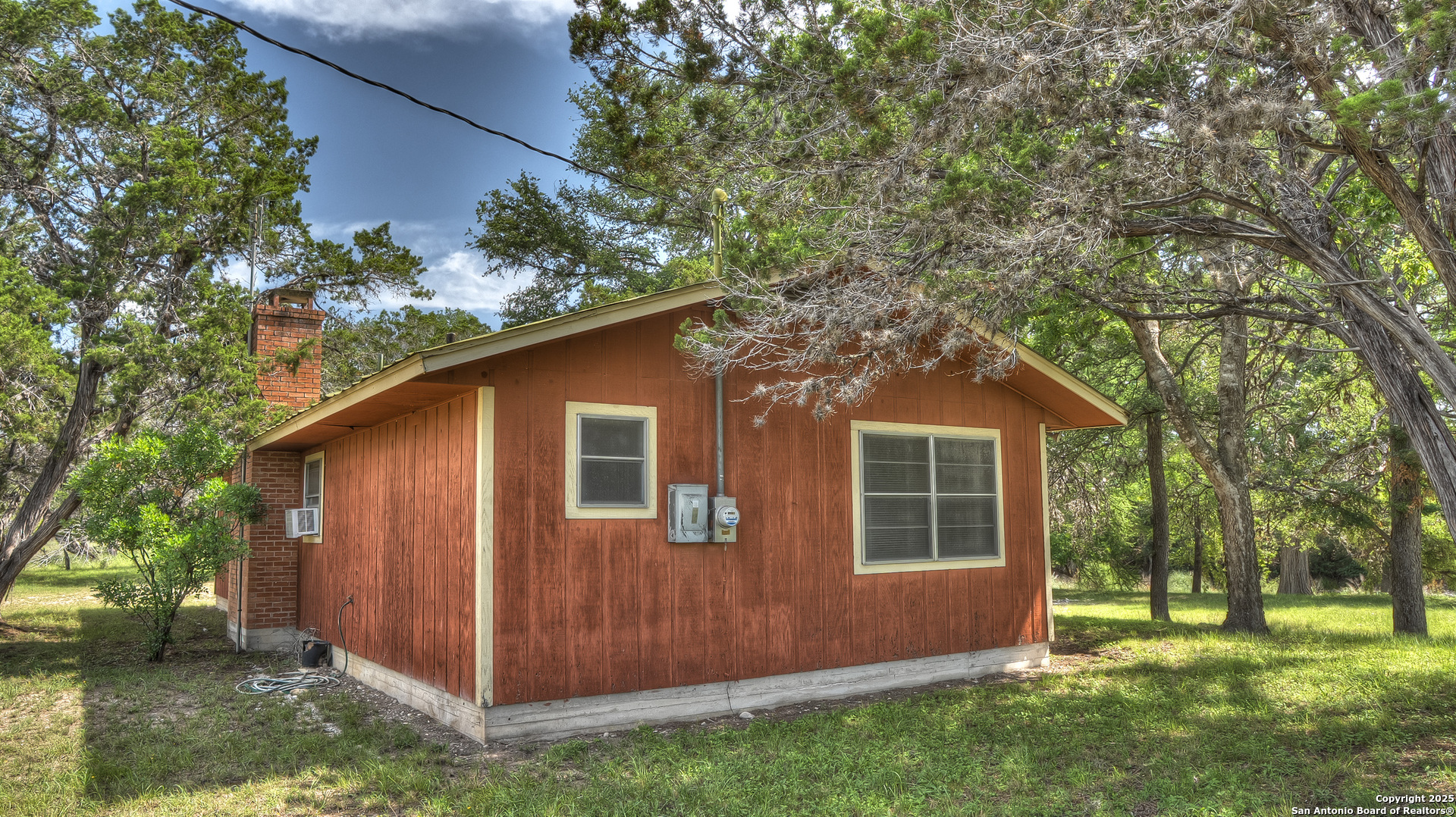 154 Weston Road Leakey, TX 78873 - Photo 4 of 39 a view of backyard with a barn and large trees