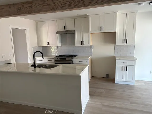 a kitchen with stainless steel appliances and a sink