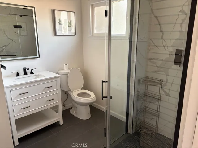 a bathroom with a toilet sink and shower